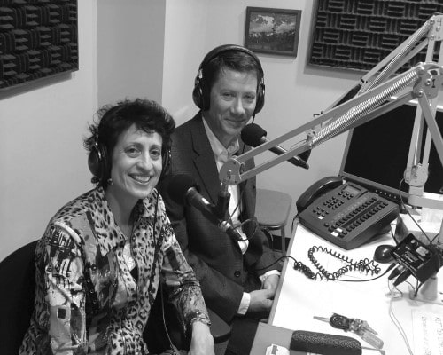 diane grubis and john in a radio station on the microphone