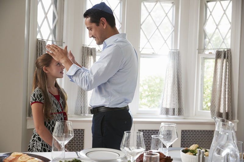 father praying a blessing over his kid